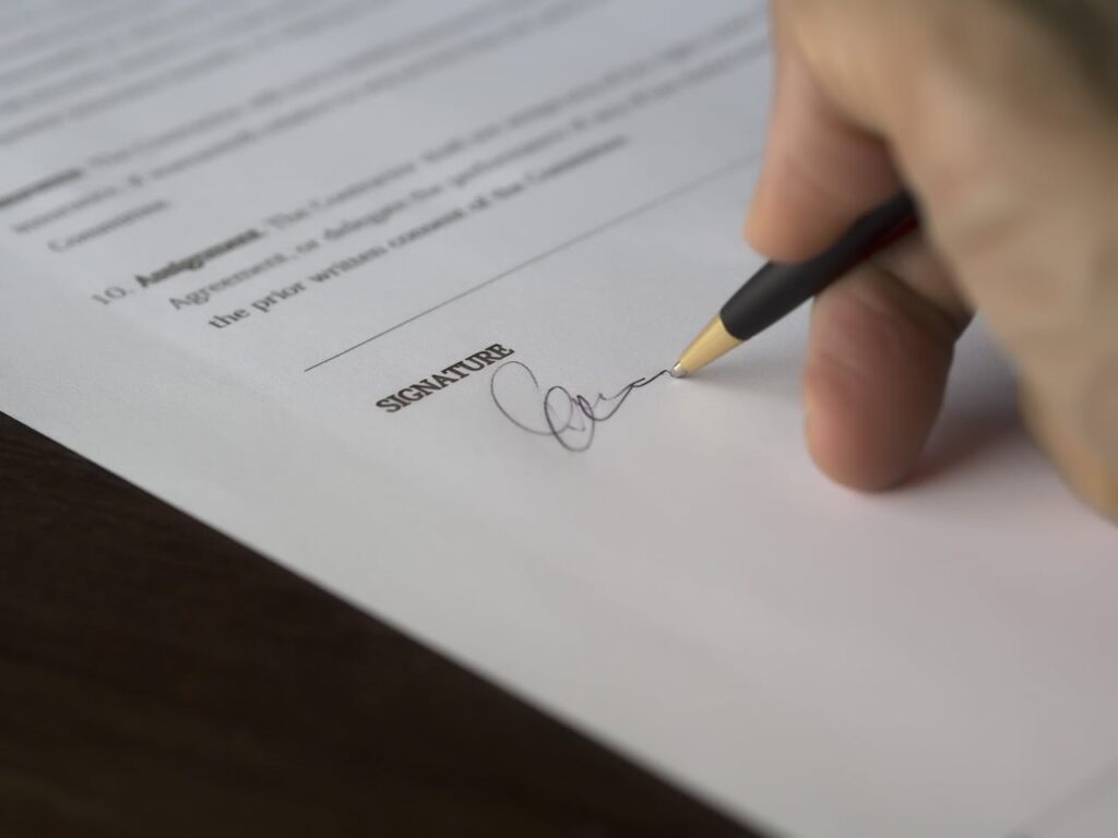 pexels-photo-261621 Selective Focus Photography of Person Signing on Paper